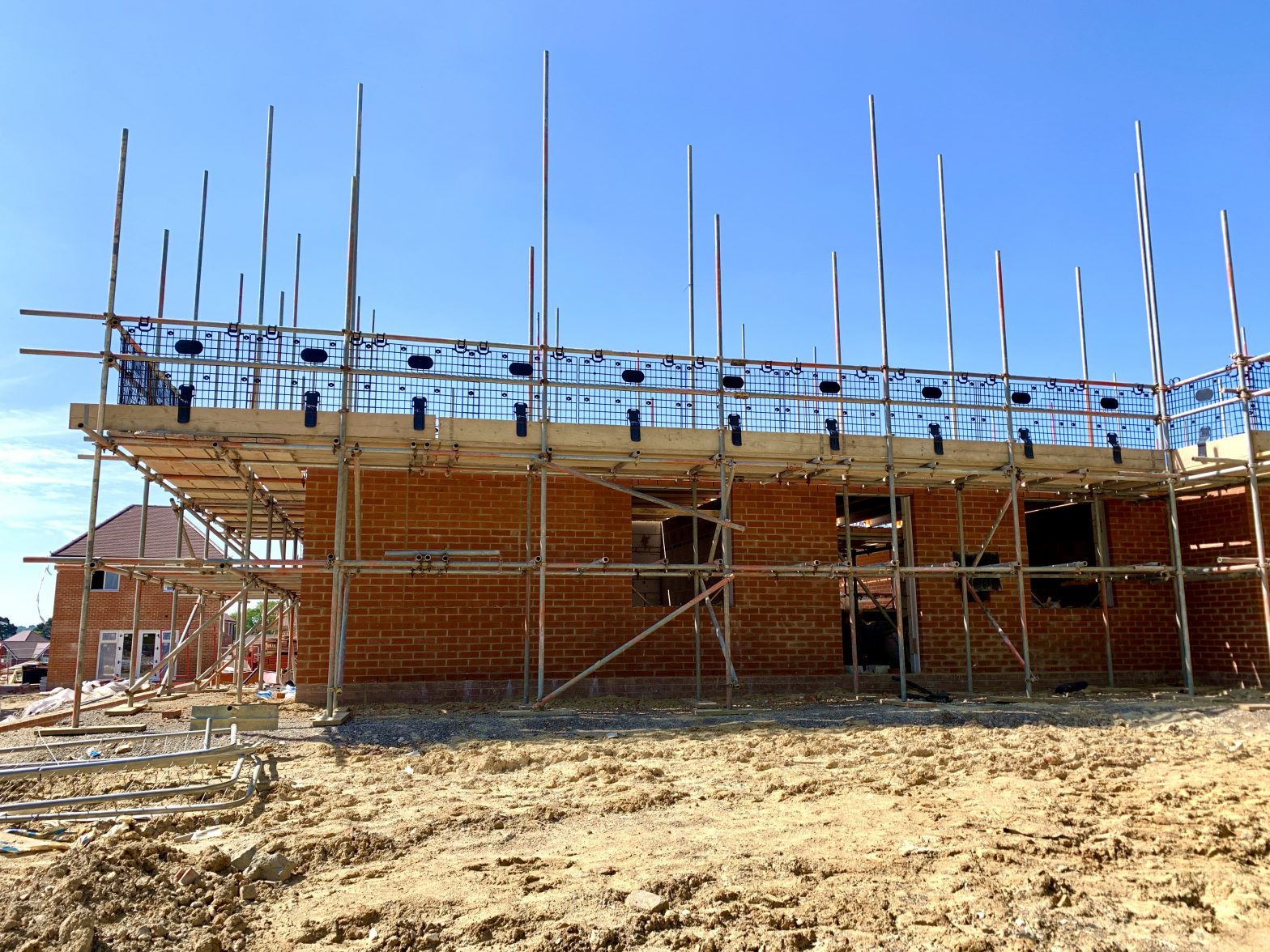 Cold Ash Parish building site showing a half built house with scaffold poles.